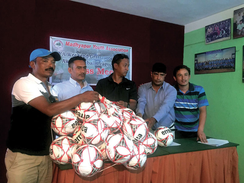Director of Grassroots Football Academy Raju Shrestha handing over balls to MYA nofficials at a press meet in Kathmandu on Thursday, May 25, 2017. Photo: THT