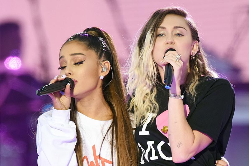 In this Sunday, June 4, 2017, handout photo provided by Dave Hogan for One Love Manchester, singers Ariana Grande, left, and Miley Cyrus perform at the One Love Manchester tribute concert in Manchester, north western England. Photo: AP