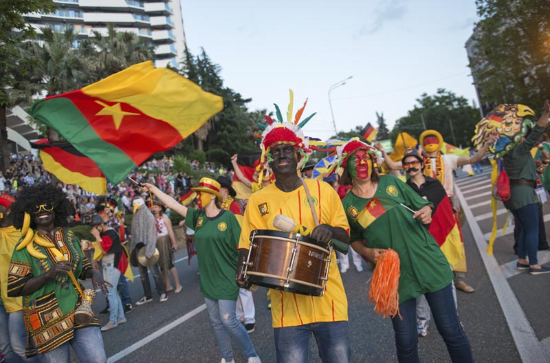 People carrying a Cameroon flag, take part in a parade in the Black Sea resort of Sochi, Russia, on Saturday, May 27, 2017. Photo: AP