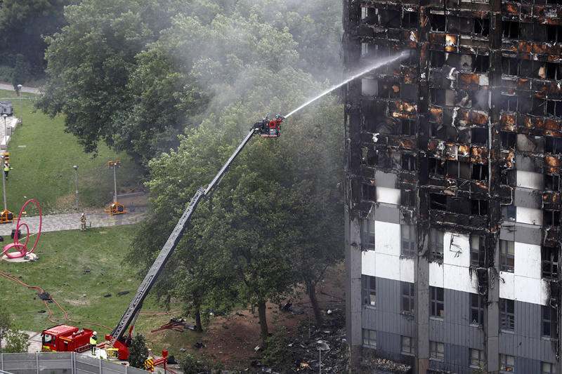 Firefighters continue to tackle fire in the tower block that was destroyed in a fire disaster, in north Kensington, West London, Britain June 15, 2017. Photo: Reuters