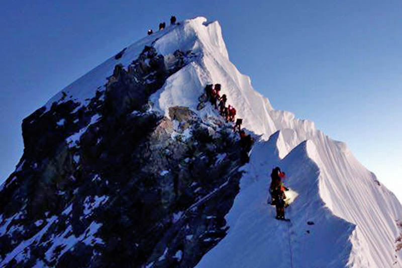Climbers crossing Hillary step as they ascend towards Everest summit. Courtesy: Pasang Rinzee Sherpa