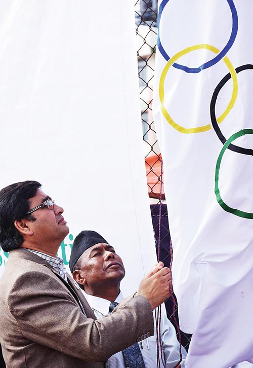 NOC President Jeevan Ram Shrestha hoisting the Olympic flag during the inauguration of the nOlympic Day celebration in Lalitpur, on Saturday. Photo: THT