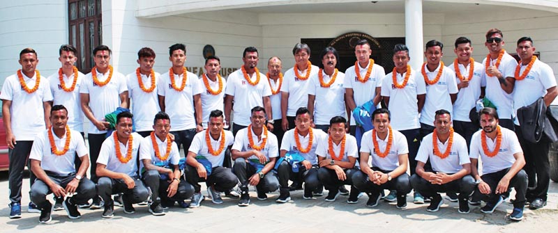 Nepal national football team members pose for group photo before their departure to India to play a friendly match, in Lalitpur, on Sunday. Photo: THT