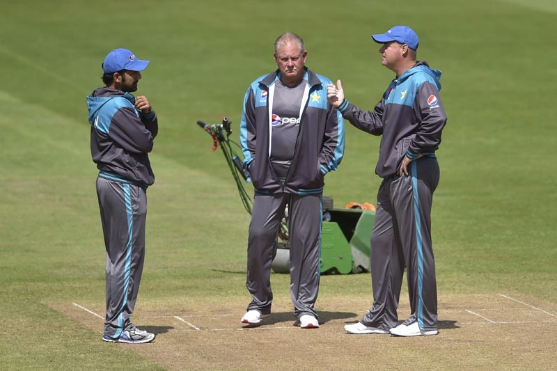 Pakistan captain Sarfraz Ahmed, (left), fielding coach Steve Rixon and head coach Mickey Arthur, (right), stand and talk on the pitch during the nets session at Cardiff Wales Stadium, Cardiff, on Tuesday June 13, 2017. Photo: Joe Giddens/PA via AP