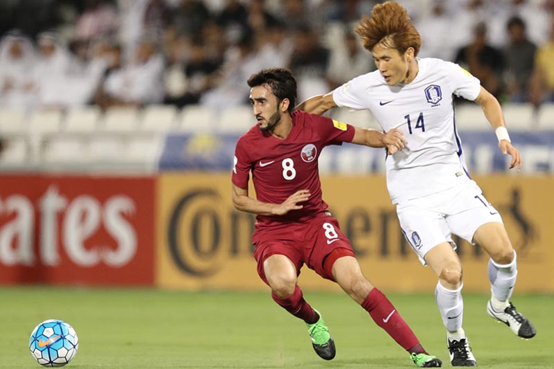 Qatar's Ali Assadalla fights for the ball with South Korea's Han Kook Young. Photo: Reuters