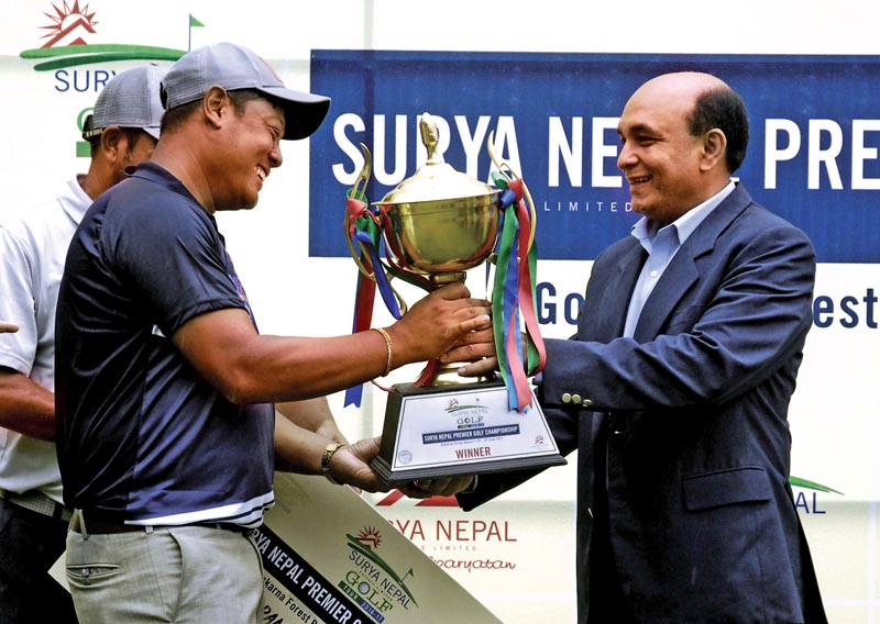 Managing Director of Surya Nepal Pvt Ltd Abhimanyu Poddar handing over the trophy to Shiva Ram Shrestha (left) after the Surya Nepal Premier Golf Championship at the Gokarna Golf Club in Kathmandu, on Thursday. Photo: Naresh Shrestha/ THT