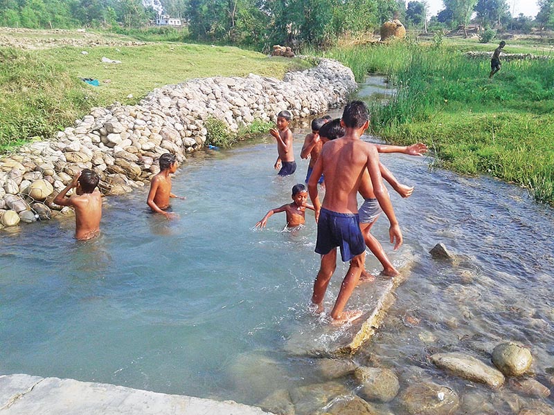 Boys cooling off in a stream on a hot summer day in Sisaiya of Bedkot Municipality, Kanchanpur, on Friday, June 16, 2017. Photo: THT
