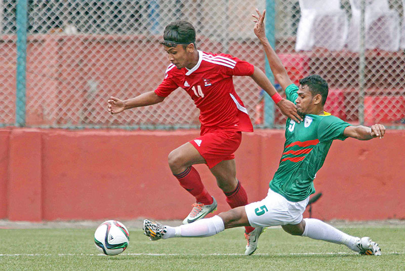 Nepal U-23 team's Anjan Bista vies for a ball with a Bangladeshi player during an International friendly match at ANFA Complex in Lalitpur on Tuesdday, July 11, 2017. Photo: Udipt Singh Chhetry
