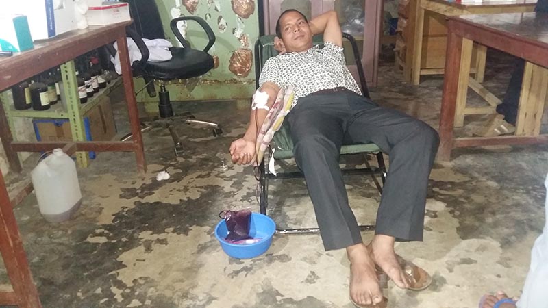 Tikaram Rai, a surgeon at the Emergency Maternity Centre of District Health Office, Bajura,  donating blood for his own patient, on Thursday, July 27, 2017. Photo: Prakash Singh/THT