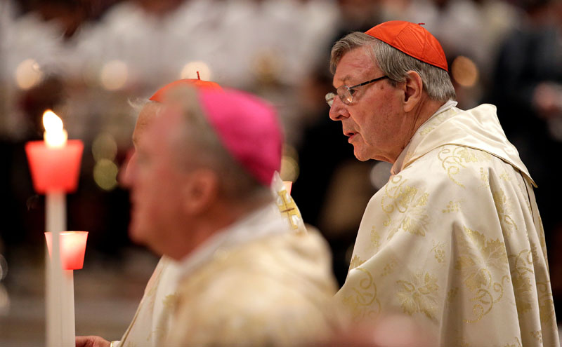 Australian Cardinal George Pell holds a candle as Pope Francis leads the Easter vigil mass in Saint Peter's Basilica at the Vatican, on April 15, 2017. Photo: Reuters