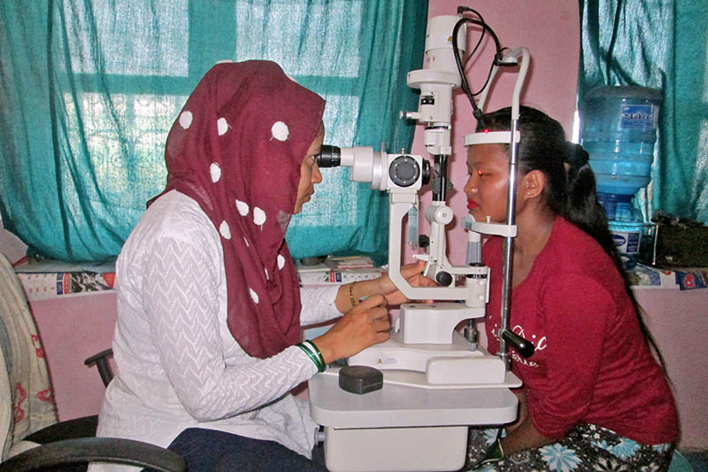 An optician examines eye of a patient at the Dhamauli Hospital in Tanahun district, on Tuesday, July 18, 2017. Photo: Madan Wagle