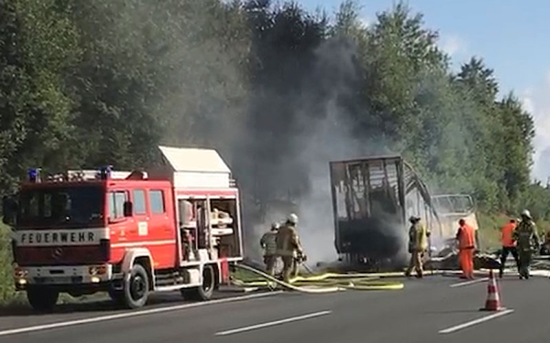 Firefighters walk at the site where a coach burst into flames after colliding with a lorry on a motorway near Muenchberg, Germany, on July 3, 2017. Photo: Reuters