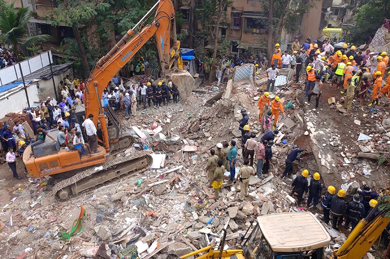 Firefighters and rescue workers search for survivors at the site of a collapsed building in the suburbs of Mumbai, India, on July 25, 2017. Photo: Reuters/ File
