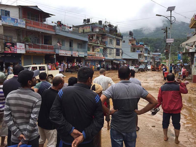 Locals observing the mud and boulders brought by the flood in Khahare area of Pokhara-Lekhnath Metropolis, on Monday, July 17, 2017. Photo: THT