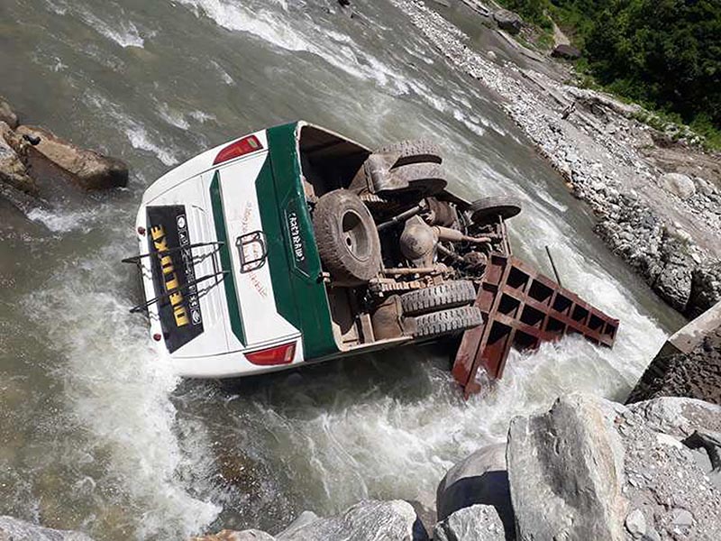 A bus heading to Beluwabesi of Kaski from Pokhara fell in the Rudi River as the bridge gave way while the bus was crossing the river in Lamjung on Thursday, July 27, 2017. Photo: RSS
