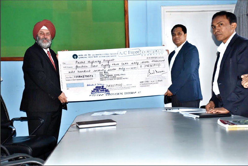 Ambassador of India Manjeev Singh Puri handing over a cheque of INR 148.37 million to Devendra Karki, secretary at the Ministry of Physical Infrastructure and Transport, in Kathmandu, on Wednesday, July 20, 2017. Photo: THT
