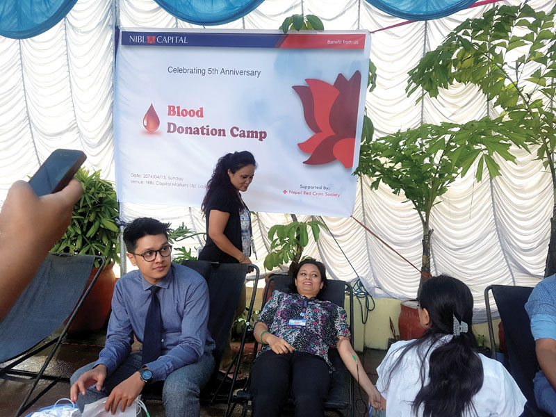 People donating blood at a blood donation programme organised by NIBL Capital to mark its fifth anniversary, in Kathmandu, on Sunday, July 30, 2017. Photo: THT