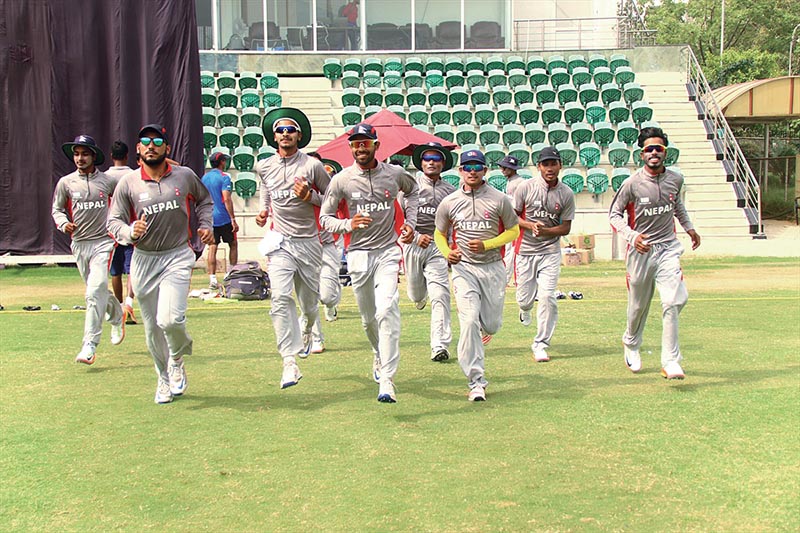 Nepal U-19 cricket team players enter the pitch for their practice match against Noida XI in Greater Noida, India, on Tuesday. Photo Courtesy: Raman Shiwakoti