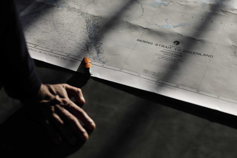 Polar maritime lawyer Scott Joblin, from the Australian National University in Cambria, looks over a map aboard the Finnish icebreaker MSV Nordica as it sets sail in the North Pacific Ocean toward the Bering Strait, on Thursday, July 6, 2017. Photo: AP