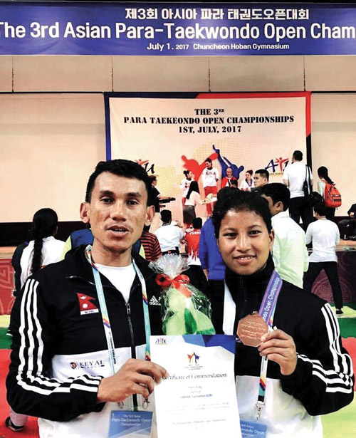 Nepal's Ranjana Dhami displays her bronze medal as she poses with coach Kabiraj Negi Lama after the third Asian Para-taekwondo Open Championship in Chuncheon, on Saturday. Photo: THT