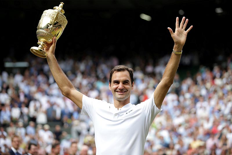 Switzerlandu2019s Roger Federer poses with the trophy as he celebrates winning the final against Croatiau2019s Marin Cilic, at Wimbledon, in London, Britain, on July 16, 2017. Photo: Reuters