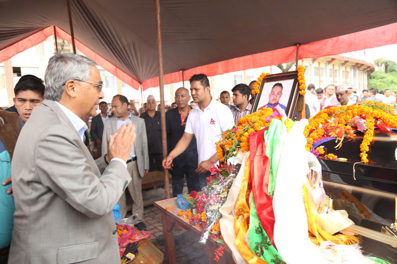 Prime Minister Sher Bahadur Deuba pays his final tribute to mountaineer Sanjay Pandit at the National Sports Council in Tripureshwor of Kathmandu on July 25, 2017. Photo: RSS