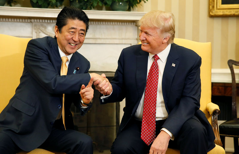 File - Japanese Prime Minister Shinzo Abe shakes hands with US President Donald Trump (right) during their meeting in the Oval Office at the White House in Washington, US, on February 10, 2017. Photo: Reuters
