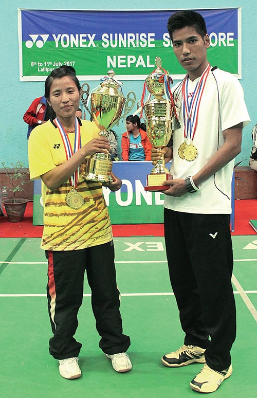 Tamang siblings Ratnajit and Nangshal Devi of TAC hold the winnersu2019 trophies after the sixth Pushpa Lal Memorial National Open Badminton Tournament, in Lalitpur. Photo: THT