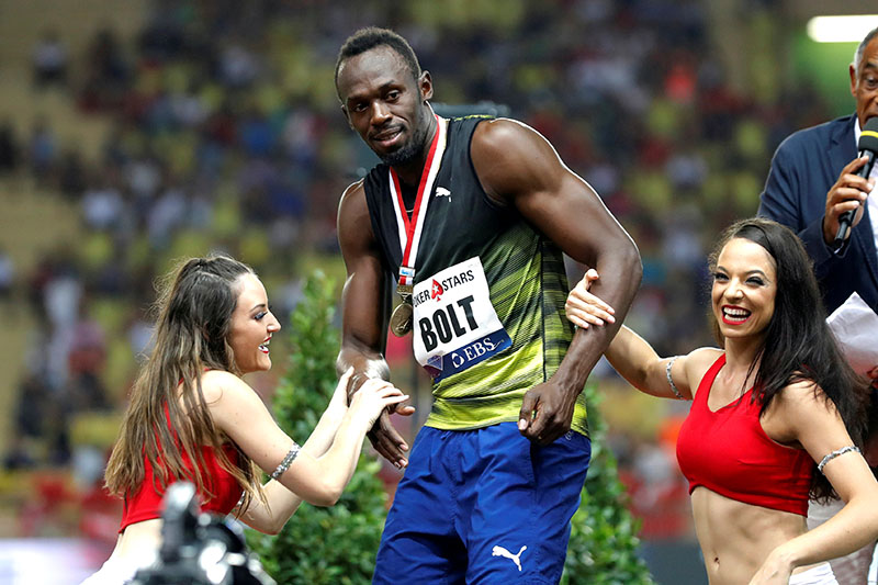 Jamaican sprinter Usain Bolt reacts with dancers. Photo: Reuters
