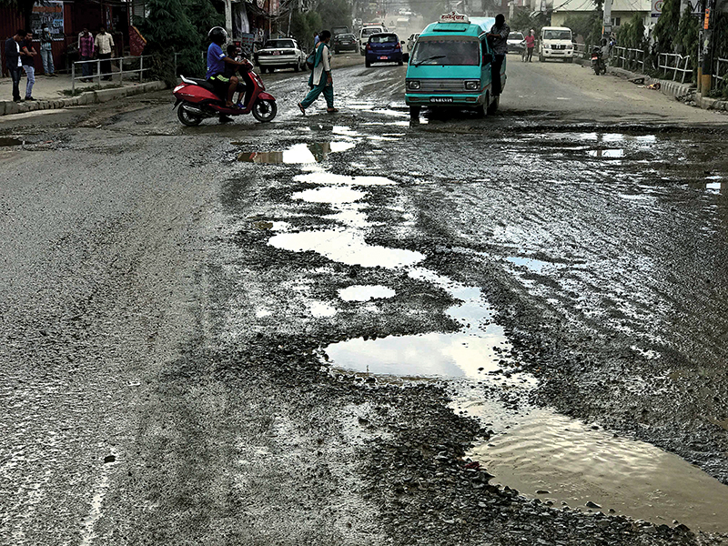 A road riddled with potholes in Ratopul, Kathmandu, on Tuesday. Photo: THT
