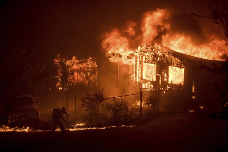 Flames from a wildfire consume a residence near Oroville, California, on Sunday, July 9, 2017. Photo: AP