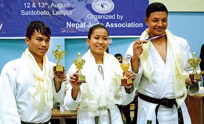 (From left) Roshan Bahadur Dong, Manita Shrestha Pradhan and Shree Ram Makaju after the eighth Ambika Bahadur Chhetri Memorial Open Judo Tournament in Lalitpur, on Sunday. Photo: THT