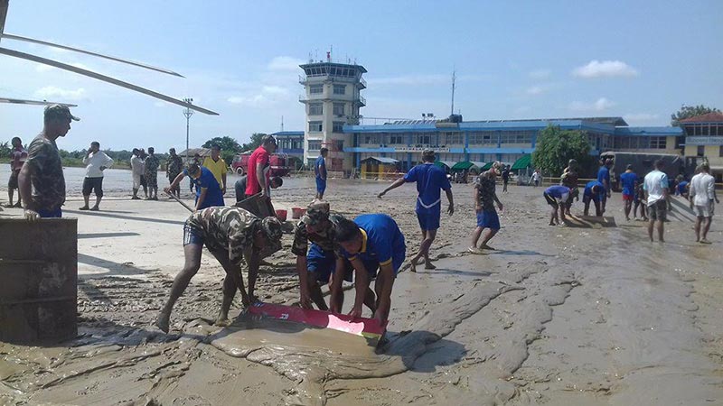 A Nepali Army team clearing  Biratnagar airport, which was inundated after heavy rainfall, in Morang, on Monday, August 14, 2017. Photo: THT