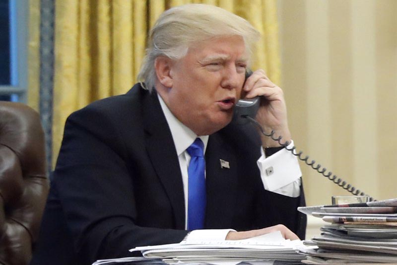 President Donald Trump speaks on the phone with Australian Prime Minister Malcolm Turnbull in the Oval Office of the White House in Washington, on January 28, 2017.