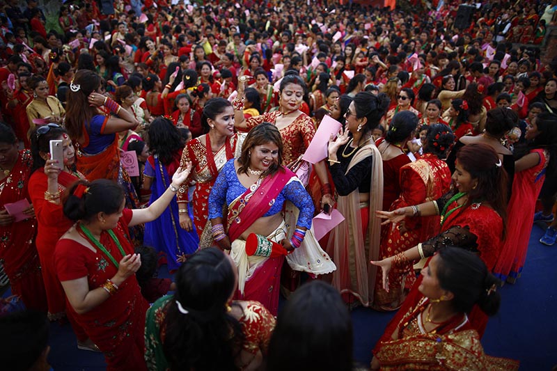 Hindu women dance and sing to celebrate Teej festival in Pashupathinath Temple area, in Kathmandu, on Thursday, August 24, 2017.  Photo: Skanda Gautam