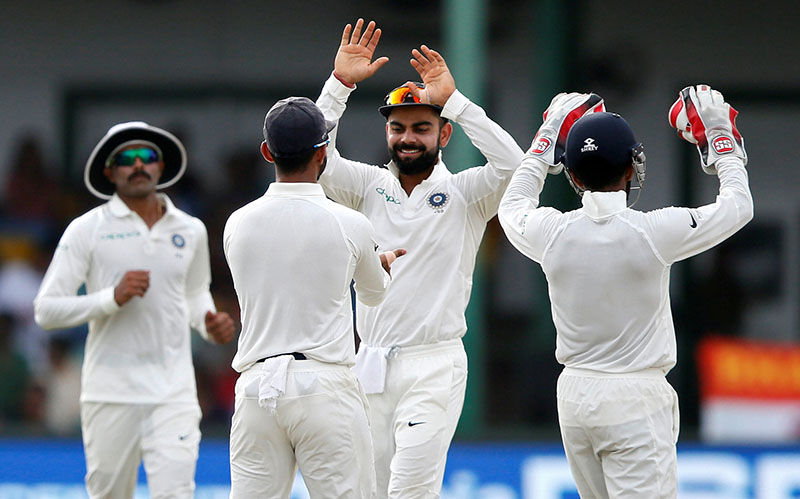 India's captain Virat Kohli celebrates with his teammates the dismissal of Sri Lanka's Dimuth Karunaratne. Photo: Reuters