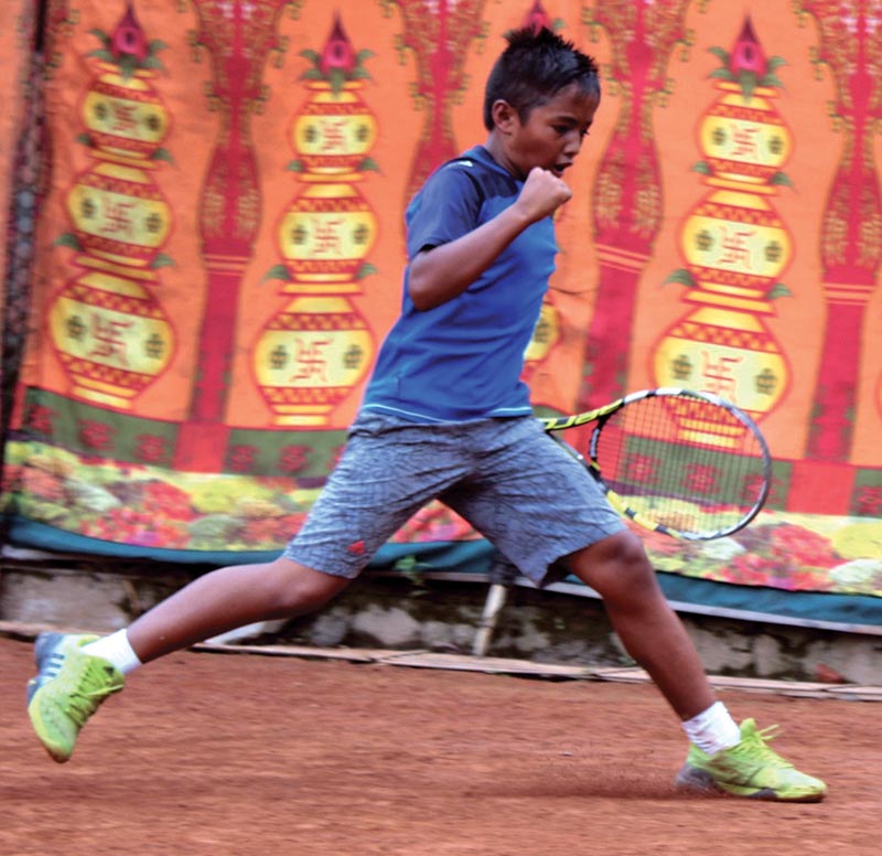 Aditya Subedi celebreates a point against Nischal Adhikari during their U-12 boys' singles match of the 10th LA-JTI Inter-school Junior Open Tennis Tournament in Lalitpur, Monday. Photo: THT