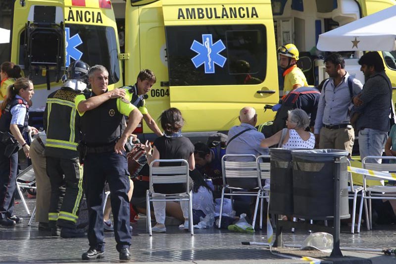 Injured people are treated in Barcelona, Spain, Thursday, August 17, 2017 after a white van jumped the sidewalk in the historic Las Ramblas district, crashing into a summer crowd of residents and tourists and injuring several people, police said. Photo: AP