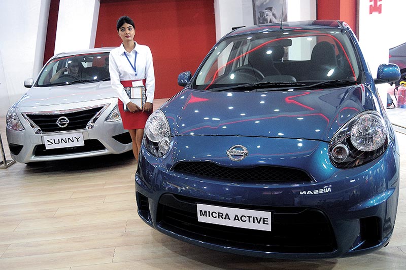 A model standing next to a car being displayed at the NADA Auto Show in Kathmandu, on Tuesday. Photo: THT