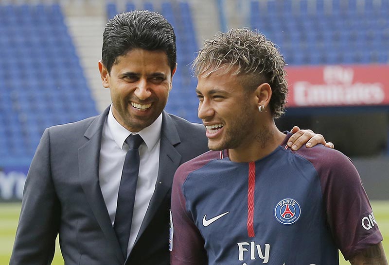 Brazilian soccer star Neymar walks away with the chairman of Paris Saint-Germain Nasser Al-Khelaifi (left) following a press conference in Paris, on Friday, Aug. 4, 2017. Photo: AP
