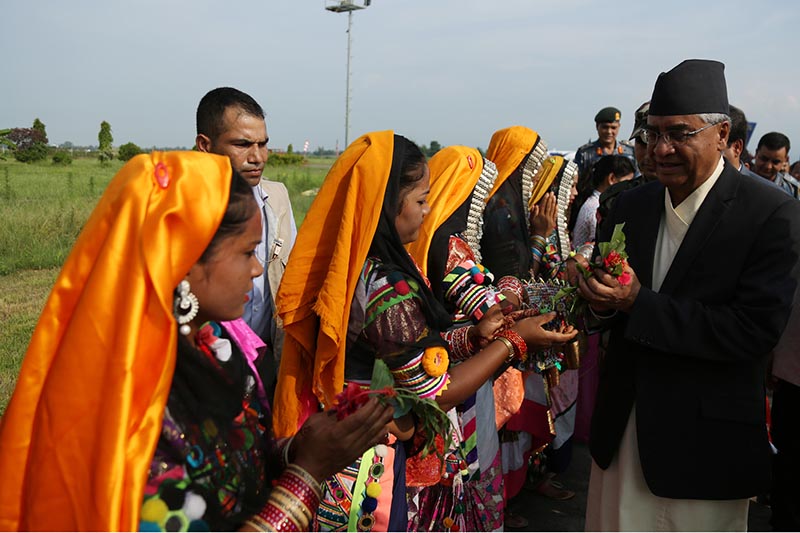 Women from local community welcome Prime Minister Sher Bahadur Deuba at the Dhangadhi Airport in Kailali district, on Thursday, August 31, 2017. The PM is due to lay a foundation stone for the construction of a four-lane bridge over the Mahakali River in Kanchanpur today. Photo: RSS