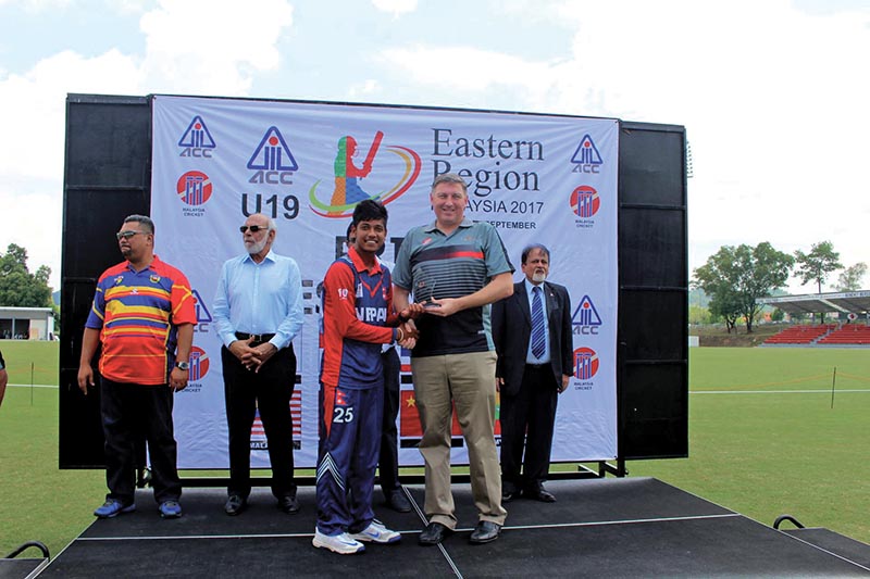 Nepalu2019s Sandeep Lamichhane receives the player-of-the-series trophy after the ACC U-19 Eastern Regional Tournament at the Club Aman in Kuala Lumpur on Sunday. Photo Courtesy: NSJF