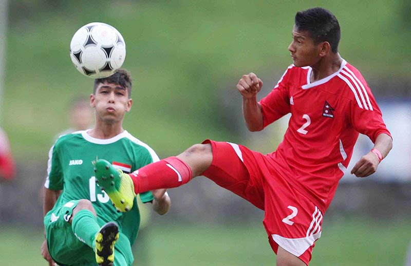 Nepalu2019s Roshan Dong (right) and Mohammed Luya Mandalawi of Iraq vie for the ball during their AFC U-16 Championship Qualifiers match at the Nepal APF Club grounds in Kathmandu on Wednesday, September 20, 2017. Photo: Udipt Singh Chhetry/THT