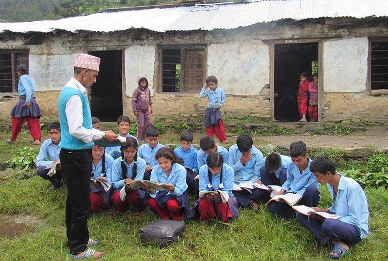 Students attending a class in the open due to lack of school building, in Rajali, Bajura, on Sunday, September 3, 2017. Photo: THT