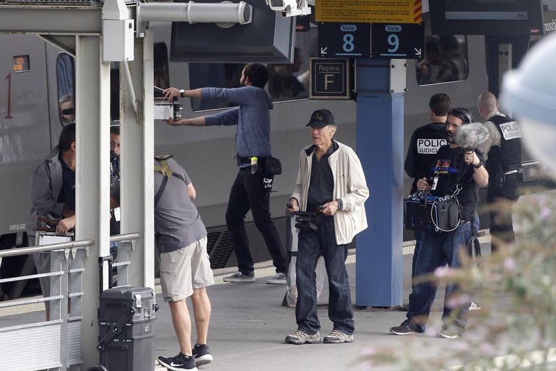 Film director Clint Eastwood, (centre), directs actors during the filming of u201cThe 15:17 to Parisu201d in Arras, northern France, Friday September1 2017. Photo: AP