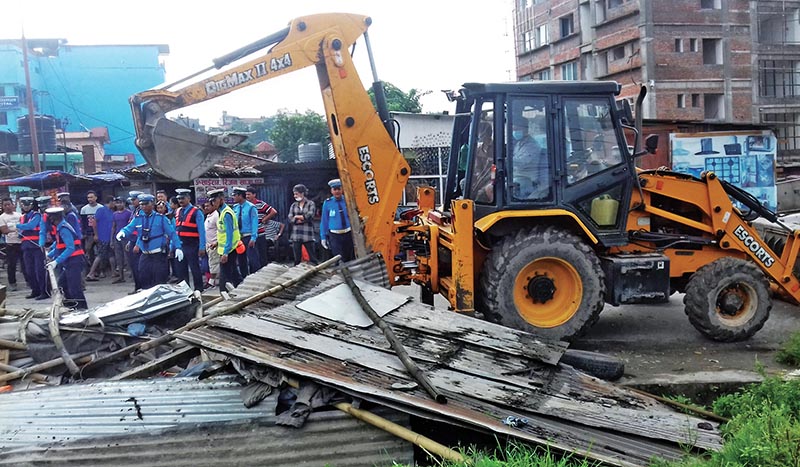 Illegally built huts being demolished at Chakrapath, Kathmandu, on Saturday. Photo: RSS