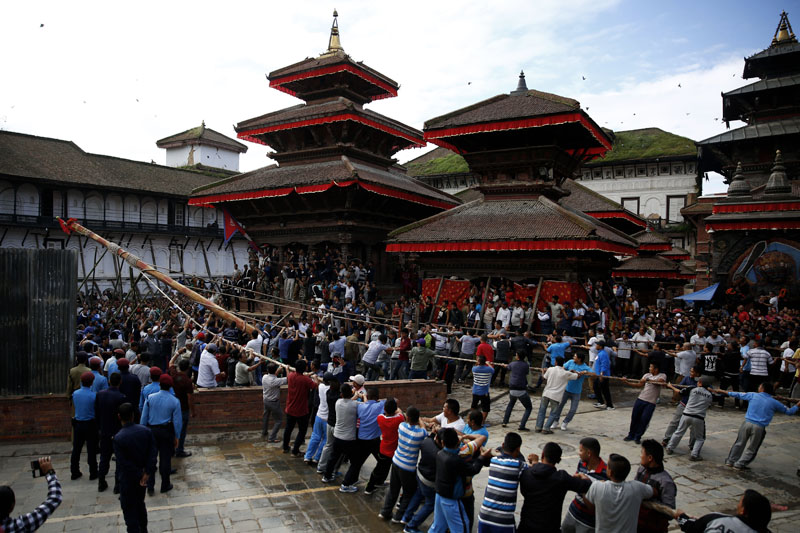 Devotees erecting the Indradhoj Linga, a ceremonial pole commencing the first day of the eight-day long Indrajatra festival, celebrated to honor Indra, the King of Heaven and Lord of Rains at Hanumandhoka in Basantapur Darbar Square, Kathmandu, on Sunday, September 3, 2017. Photo: Skanda Gautam