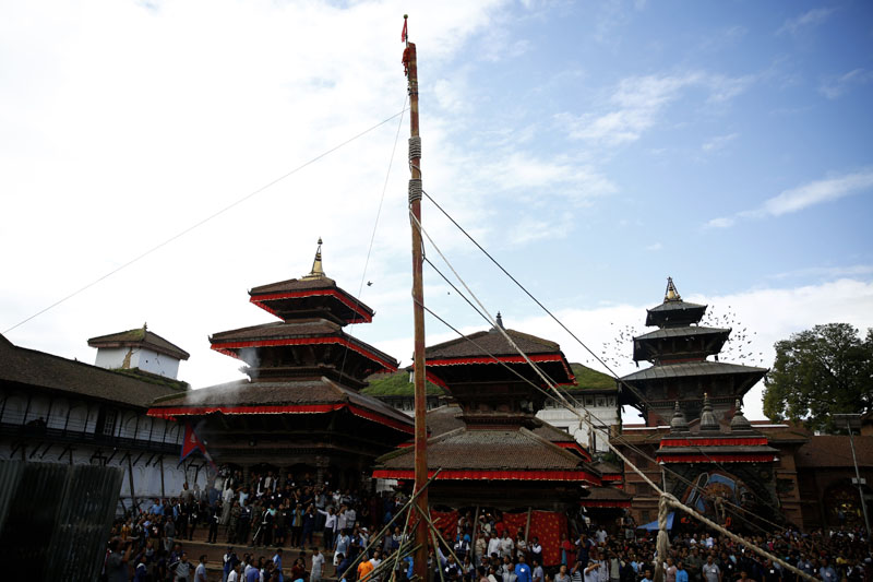 Devotees erect the Indradhoj Linga, a ceremonial pole commencing the first day of the eight-day long Indrajatra festival, celebrated to honor Indra, the King of Heaven and Lord of Rains in Hanumandhoka, Kathmandu, on Sunday, September 3, 2017. Photo: Skanda Gautam