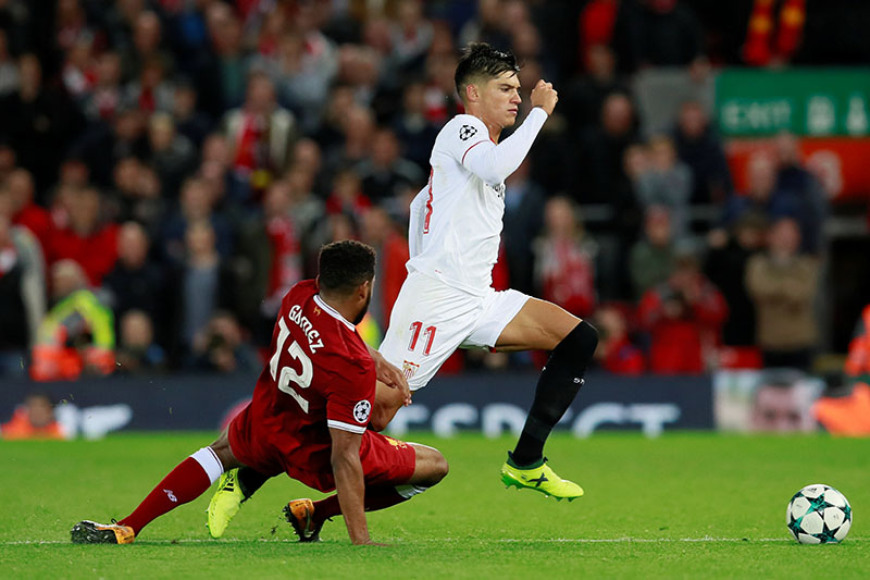 Liverpool's Joe Gomez fouls Sevillau2019s Joaquin Correa and is sent off after receiving a second yellow card. Photo: Reuters