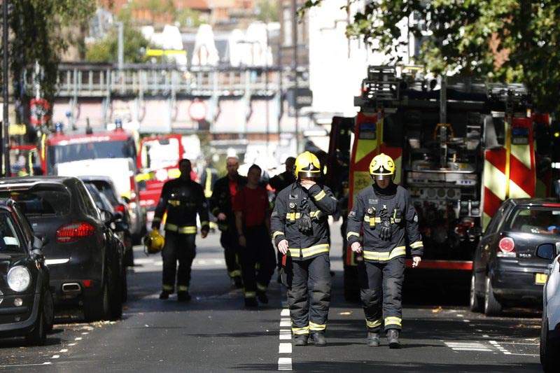 Fire brigade officers walk within a cordon near where an incident happened, that police say they are investigating as a terrorist attack, at Parsons Green subway station, in London, on Friday, September 15, 2017. Photo: AP